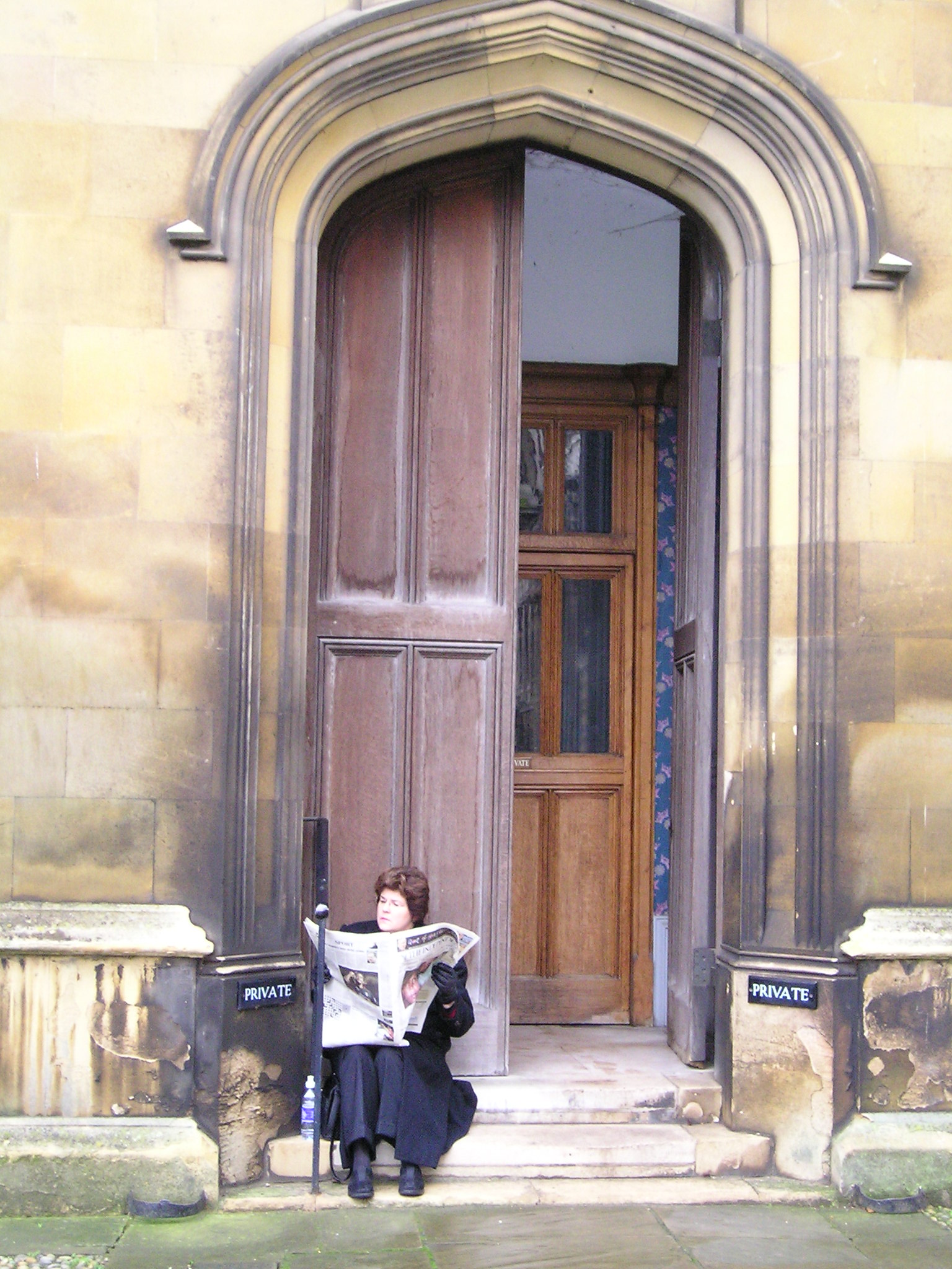 Theo's mother at King's College sitting in a doorway